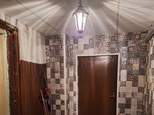 een badkamer met een deur en een lamp op een muur bij Dante? No, it's Dunte! in Rīga