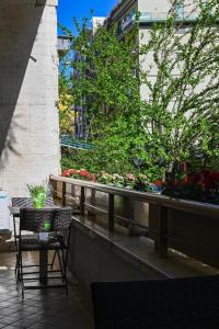 Residenza Suarez في نابولي: طاولة وكرسي على شرفة بها زهور
