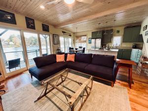 uma sala de estar com um sofá e uma mesa em Waterfront Home on Bantam Lake with Private Beach em Morris
