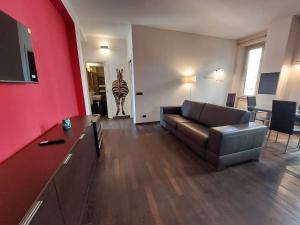 sala de estar con sofá y pared roja en Your Happy Home en Roma