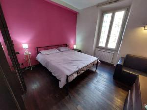 una camera da letto con un letto e una parete rosa di Your Happy Home a Roma