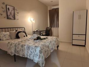a bedroom with a bed with a table and a lamp at Kluang 4 bedrooms 4 bathrooms in Kluang