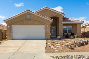 a house with a garage in front of it at Casa Chiliwood in Albuquerque