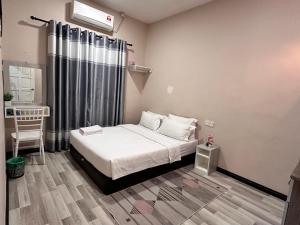 a small bedroom with a bed and a window at ANG LEE HOLIDAY HOME 1 in Semporna