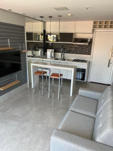 a kitchen with a couch and a table and chairs at Apartamento em águas claras in Águas Claras