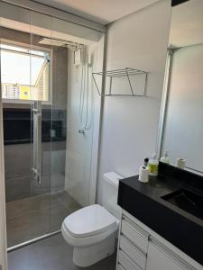 a bathroom with a shower and a toilet and a sink at Apartamento em águas claras in Águas Claras