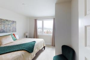 a white bedroom with a bed and a window at La Bonte Townhomes Unit 304 in Dillon
