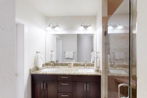 a bathroom with two sinks and a large mirror at La Bonte Townhomes Unit 304 in Dillon +35 photos