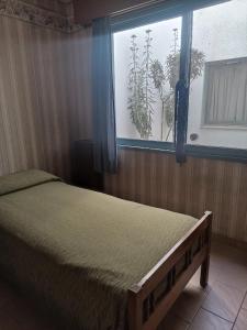 a bedroom with a bed and a window at "C" SPACIO HOSTEL - Habitación Compartida por separado para femenino o masculino- in Mendoza