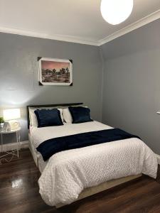 a bedroom with a large bed with blue pillows at 1 bedroom in kingscross, St Pancras, London in London