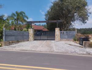 um portão para uma casa com uma entrada em Sítio na Praia da Itapeva em Torres