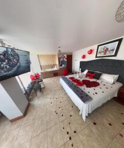 a bedroom with a large bed with roses on it at Hostal DRABA in Lima