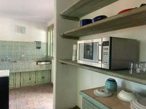 a kitchen with a microwave and a counter top at Casa Árbol Hotel in San Miguel de Allende