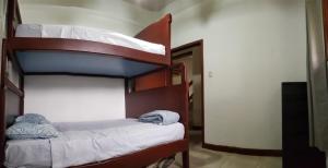 two bunk beds in a room with a hallway at Valles de Olon, Lugar encantador y acogedor para un feliz descanso. in Santa Elena