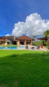 a house with a large yard with a pool at SrvittiniVillas Spacius Confort Villa Fam Team CouplesCasa de Campo Resort in La Romana