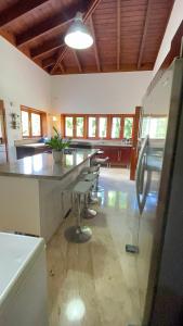 a kitchen with a long table and chairs in a room at SrvittiniVillas Spacius Confort Villa Fam Team CouplesCasa de Campo Resort in La Romana