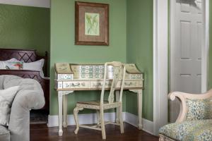 a dressing table with a chair in a bedroom at Hamilton Turner Inn in Savannah