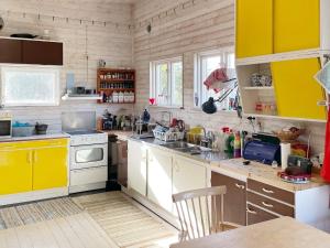 a kitchen with yellow cabinets and a counter top at 4 star holiday home in Sturkø-By Traum in Sturkö