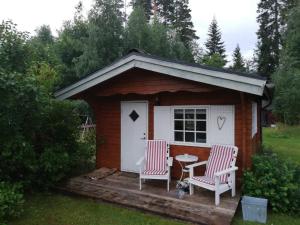 a small shed with two chairs and a table at 4 star holiday home in Skutskär-By Traum in Älvkarleby
