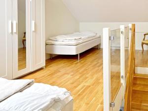 にあるHoliday home MUNSöのベッド2台と鏡が備わる客室です。