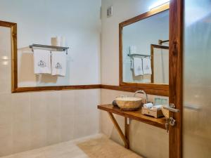a bathroom with a sink and a mirror at Komodo Resort in Sebayur