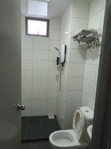 a small bathroom with a toilet and a window at Cold house in Cameron Highlands +7 photos