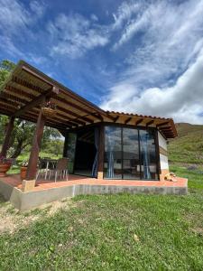 a pavilion with a table and chairs in a field at Cabañas Villa Celeste in Villa de Leyva