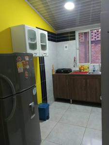 a kitchen with a refrigerator and a counter top at La Ramada Campestre in Calarcá