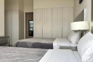 a hotel room with two beds and a lamp at Laviu B&B Luxe Suites in Puebla