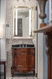a bathroom with a wooden sink and a mirror at Hamilton Turner Inn in Savannah