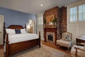 a bedroom with a bed and a fireplace at Hamilton Turner Inn in Savannah