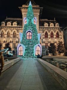 a large christmas tree in front of a building at Glamour Ultracentral in Craiova
