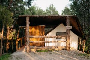 una cabaña en el bosque con una valla en Treehouse Cozy Glamping Site, en Branson