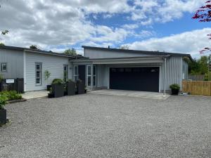 a house with a garage with a driveway at Tregandale in Greytown