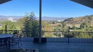 a view of a balcony with a table and chairs at VIEW PRIVATE FEMALE Short-Long Term Day-Week-Month Un-Furnished Home-House-Estate Bedrooms-Studio-ADU-Guesthouse-Vacation Rental Encino Hills 405-101 xSepulveda in Encino