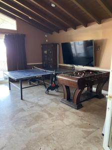 a room with a ping pong table and a tv at VIEW PRIVATE FEMALE Short-Long Term Day-Week-Month Un-Furnished Home-House-Estate Bedrooms-Studio-ADU-Guesthouse-Vacation Rental Encino Hills 405-101 xSepulveda in Encino