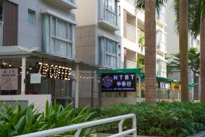a building with a sign in front of it at Apartment Scenic Valley Quận 7 in Ho Chi Minh City
