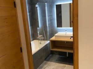 a bathroom with a sink and a shower and a mirror at Appartement charmant au pied des pistes avec balcon et parking - FR-1-692-93 in La Chapelle-dʼAbondance