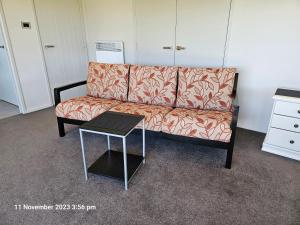 a living room with a couch and a table at House on the Hill in New Plymouth