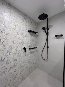 a bathroom with a shower with a shower head at Royal Palm Resort on the Beach in Gold Coast