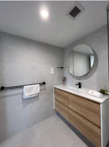 a bathroom with a sink and a mirror at Royal Palm Resort on the Beach in Gold Coast