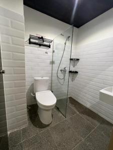 a bathroom with a toilet and a shower and a sink at Choska Residence in Jakarta