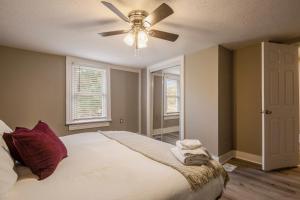 a bedroom with a bed with a ceiling fan at Newly renovated 4BR CozySuites in Louisville