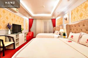 ハノイにあるHANZ Kieu Anh Hotelのベッド2台とテレビが備わるホテルルームです。