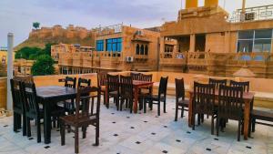 a patio with a table and chairs on a building at Royal Villa Jaisalmer in Jaisalmer