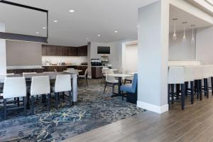 a dining room and kitchen with tables and chairs at Residence Inn Providence Coventry in West Greenwich