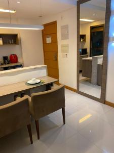 a kitchen and dining room with a table and chairs at Apart Rio Centro in Rio de Janeiro