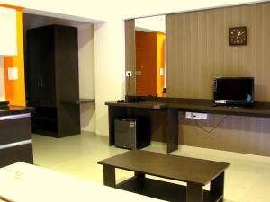 a large room with a desk and a bench in it at Infinity Lake View Studio in Lavasa
