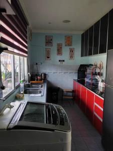 a small kitchen with a sink and a stove at Homestay Temerloh Jaya in Temerloh