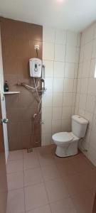 a bathroom with a toilet and a shower stall at Rovers Inn Guest House in Tanah Rata